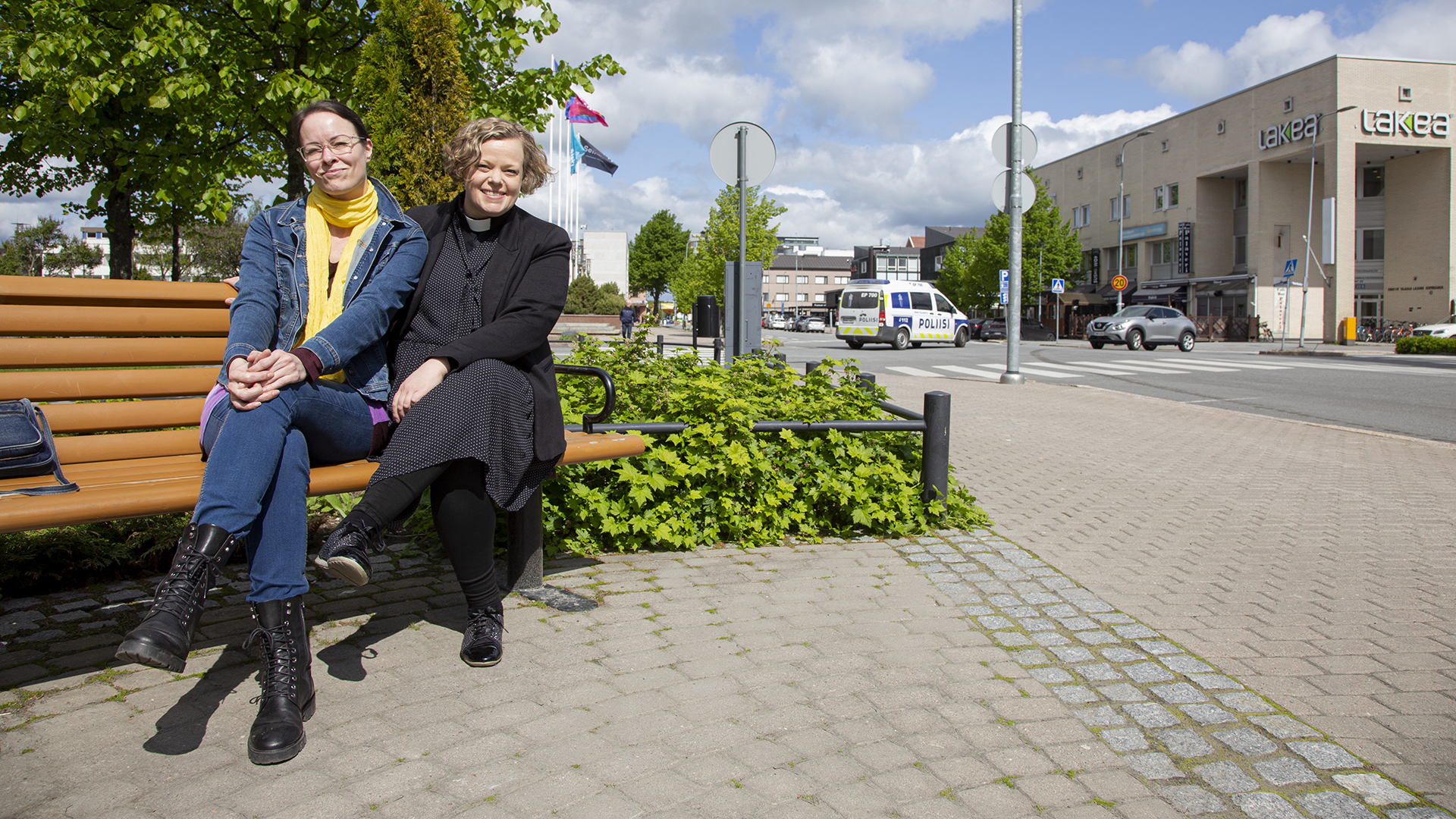 Kaksi naista istuu puiston penkillä, taustalla näkyy Seinäjoen keskustaa.